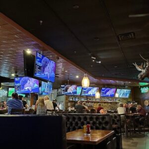 Large tvs surrounding bar area