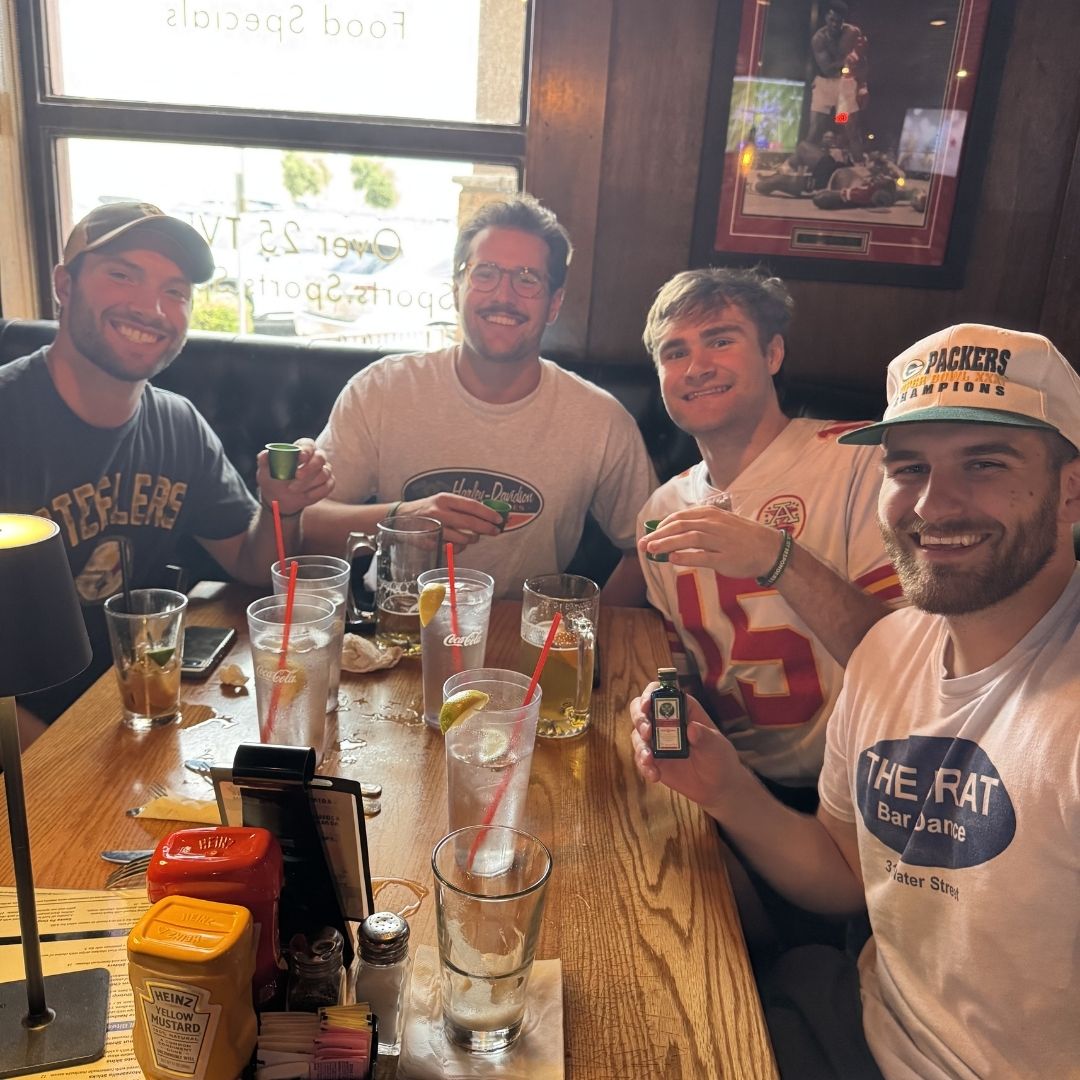 A group of men at a table getting drinks