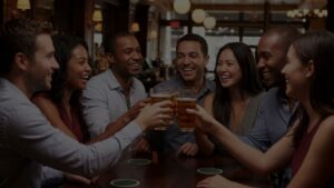 smiling couples toasting glasses during happy hour